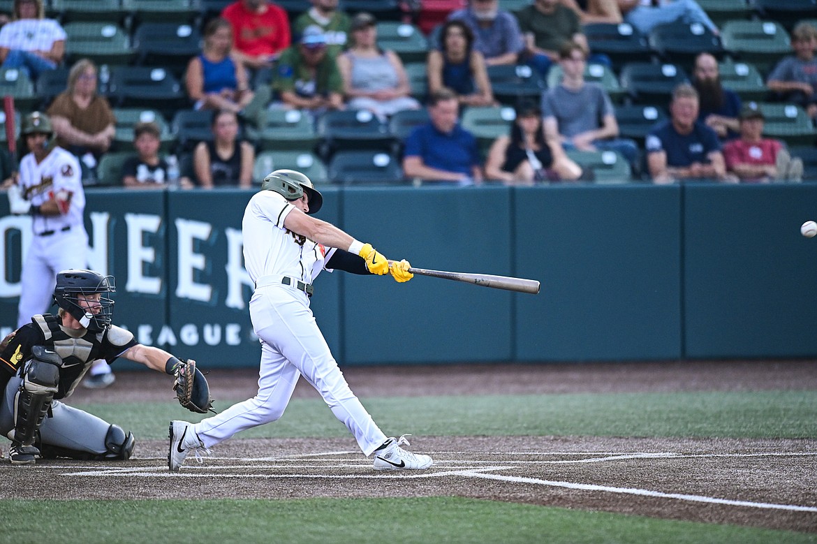 Glacier's Ben Fitzgerald (8) connects on a double in the sixth inning against Boise at Glacier Bank Park on Tuesday, July 23. (Casey Kreider/Daily Inter Lake)