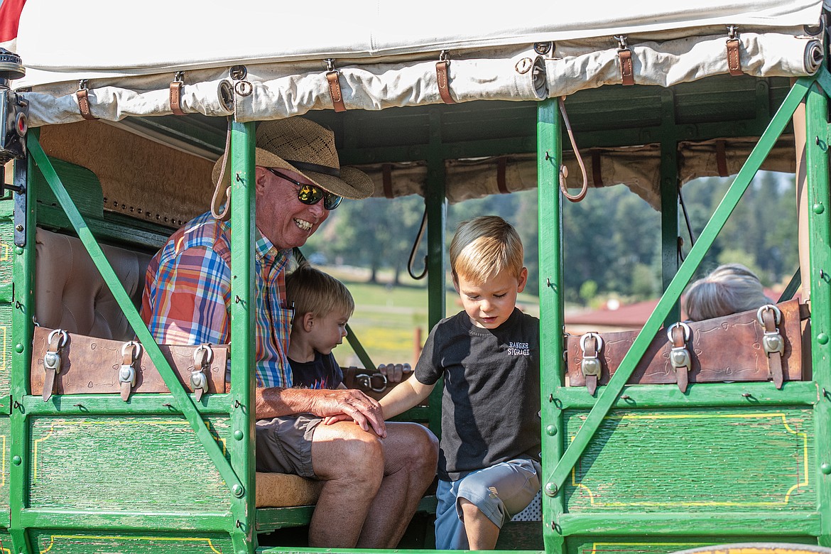 Reed Darrow, owner of Wrangler Springs Ranch, and his grandsons board a stagecoach for a ride around the grounds Friday, July 19. (Avery Howe/Bigfork Eagle)