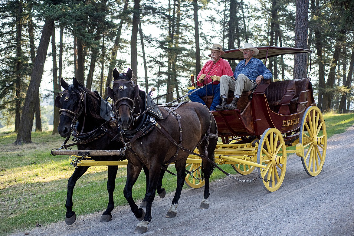 Dale Mee and Doug Howser on a stagecoach ride at Wrangler Springs Friday, July 19. (Avery Howe/Bigfork Eagle)