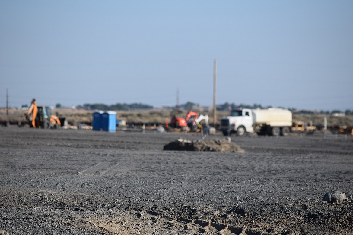 Trucks and other construction equipment sits idle after the workday at the site of the new Grant County Jail Tuesday evening. Prep for the site is just about done and those involved in the project expect vertical walls to be up soon.