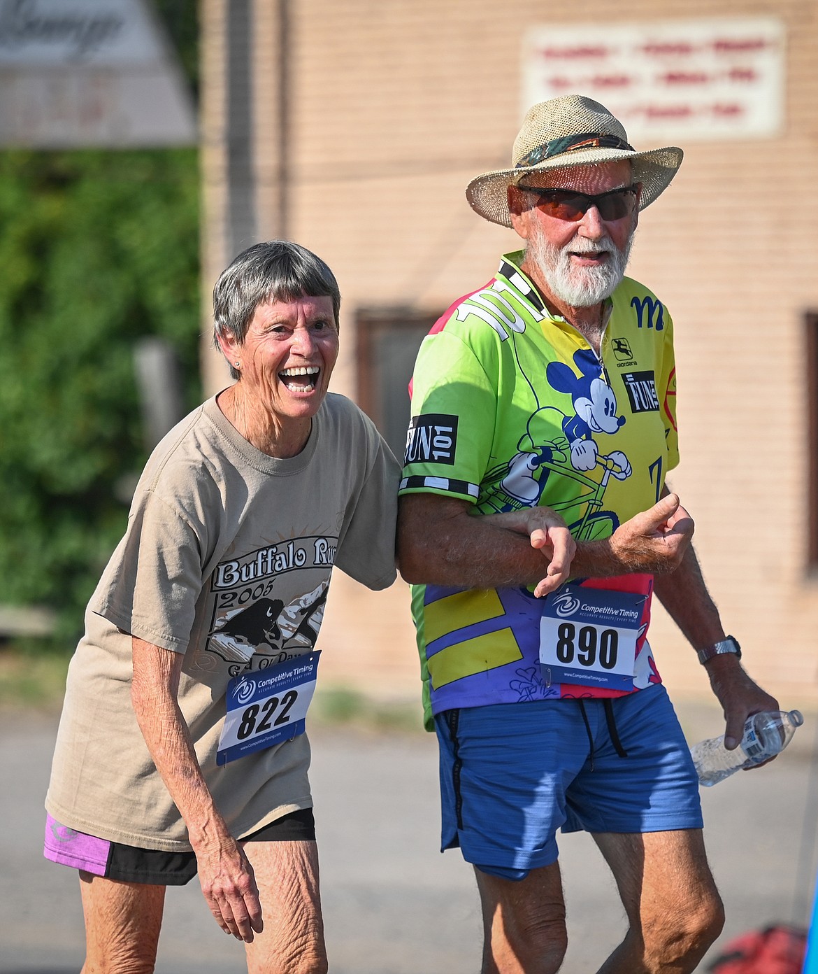 Lee Ann and Ed Gottfried reach the Buffalo Run four-mile finish line Saturday. The long-time Mission residents are no strangers to the event (Lee Ann is wearing a shirt from the 2005 race). (Christa Umphrey photo)