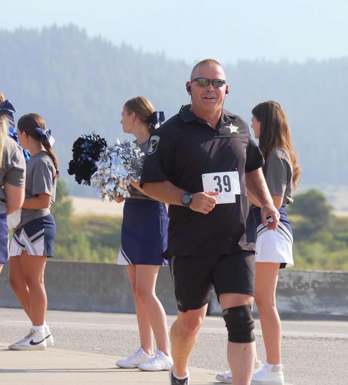 Law enforcement official runs at the Kootenai River Run.