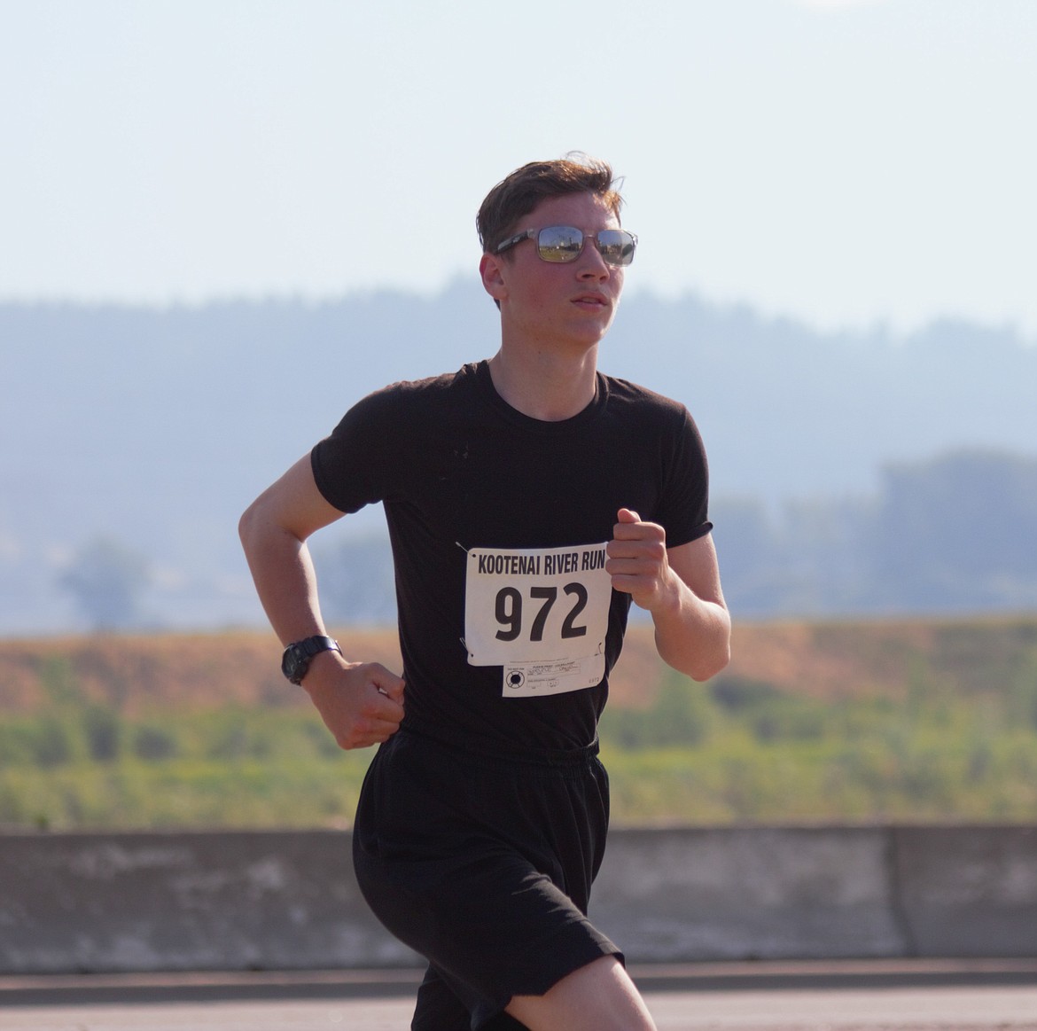 Runner rounds Riverside Street on the last stretch of the Kootenai River Run on Saturday, July 20.