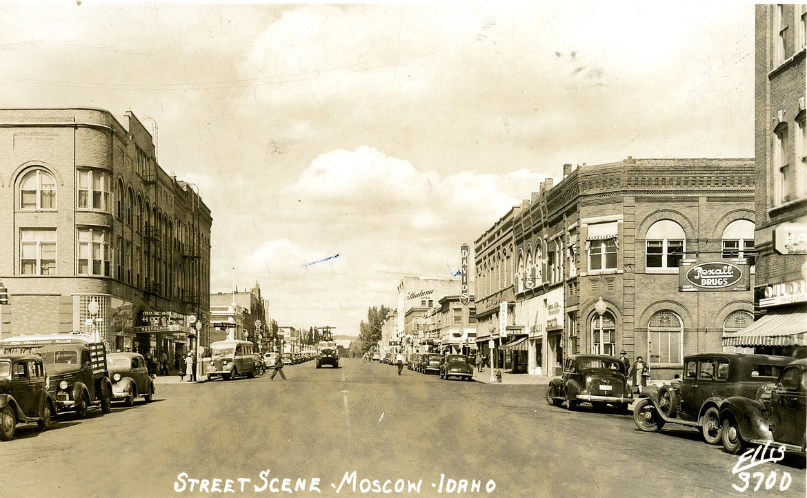 A postcard of Main Street in Moscow looking north at Rexall Drug, Moscow Hotel and Scott's Flower's and Gifts. Circa 1940.