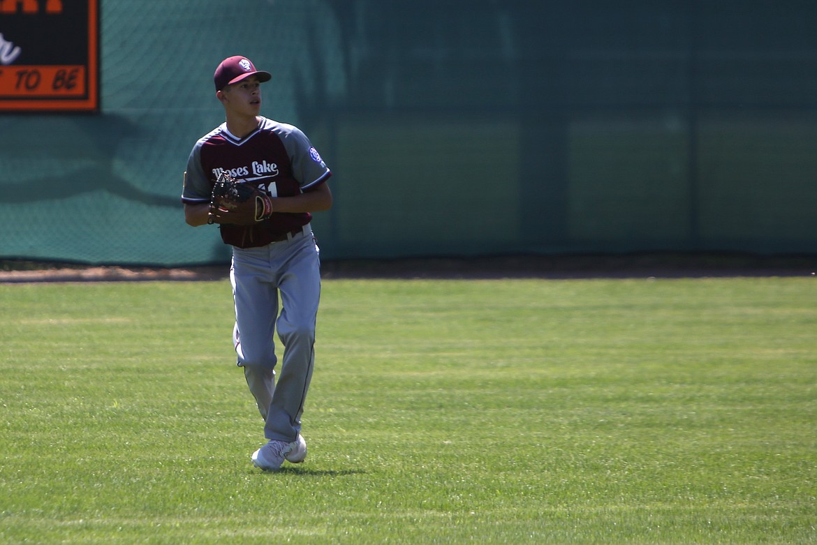 An outfielder for the Moses Lake 14U All-Stars looks back toward the infield after catching a fly ball during the 14U Babe Ruth North Washington State Tournament in Ephrata.