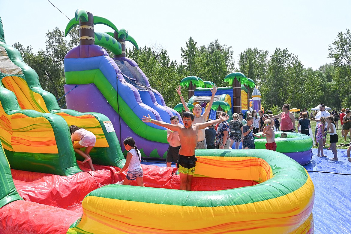 Giant inflatables supplied by the Dew Crew included bounce houses and water slides that helped keep kids cool at Good Old Days park. (Christa Umphrey photo)