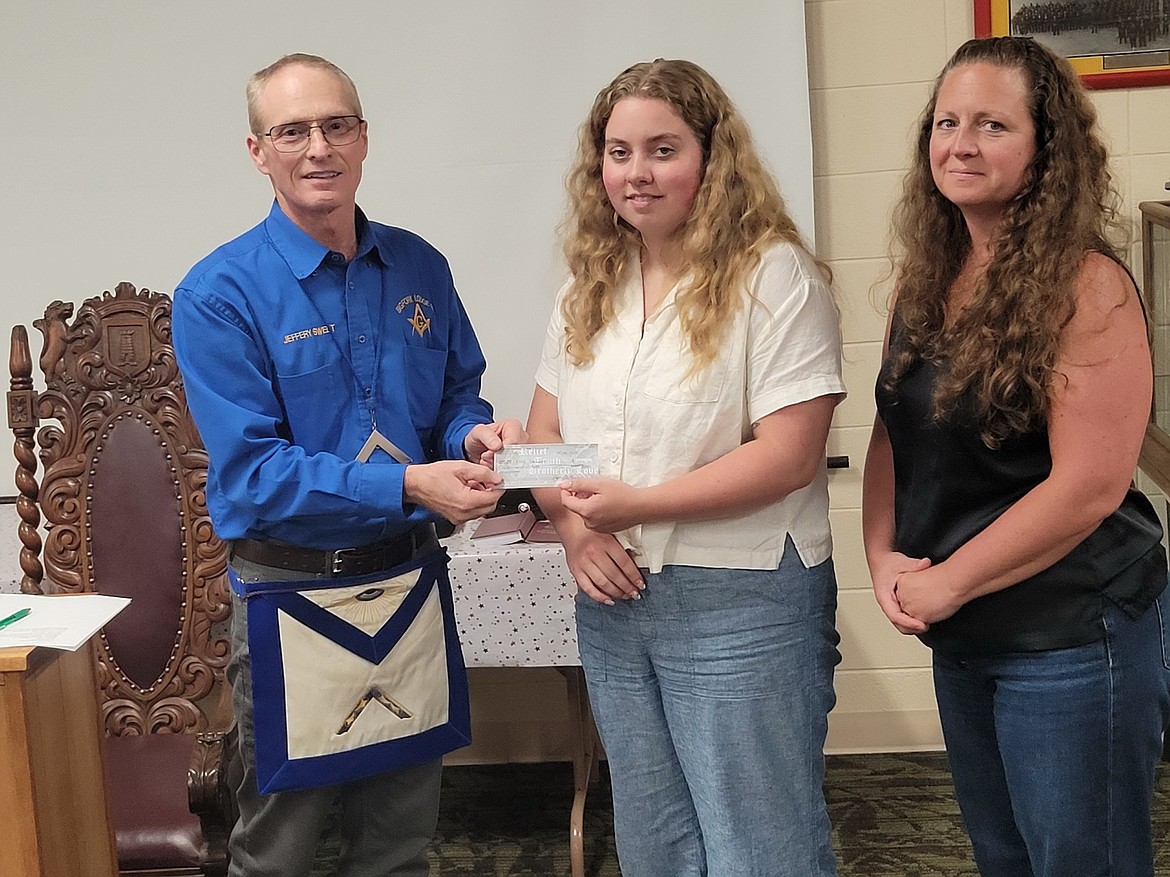 From left, Jeffrey Sweet, Master of Lodge , presents an award to Delcy Stewart with her mother Emily on July 8. (Courtesy photo)