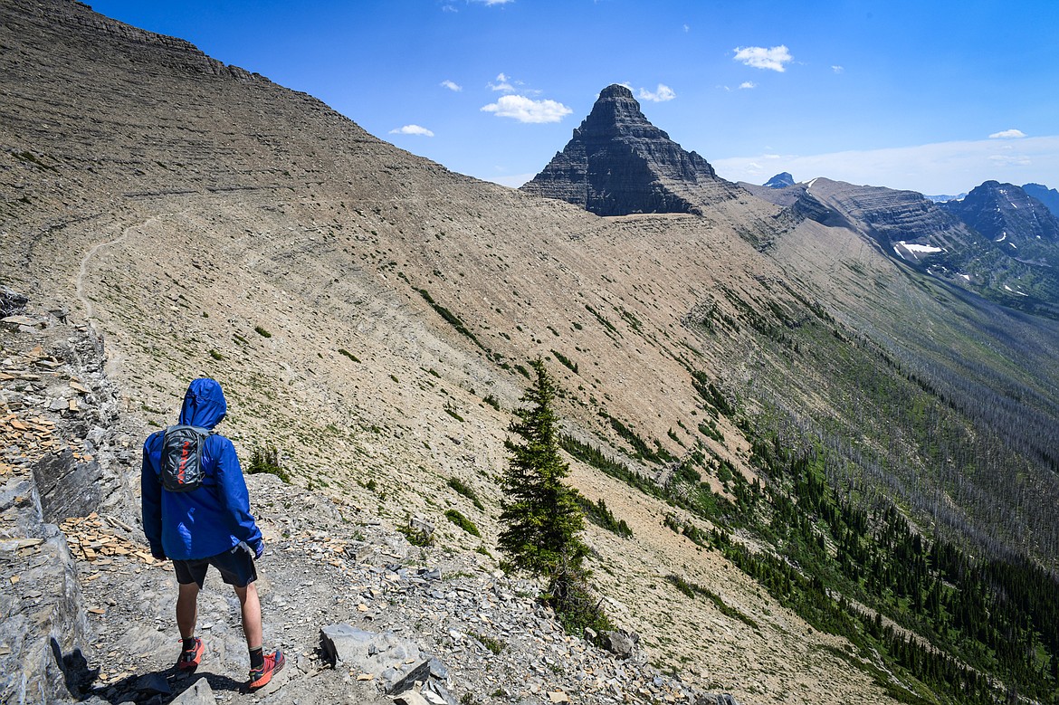 Graham Feil of Kalispell walks along the Continental Divide Trail toward Flinsch Peak in Glacier National Park on Sunday, July 14. (Casey Kreider/Daily Inter Lake)