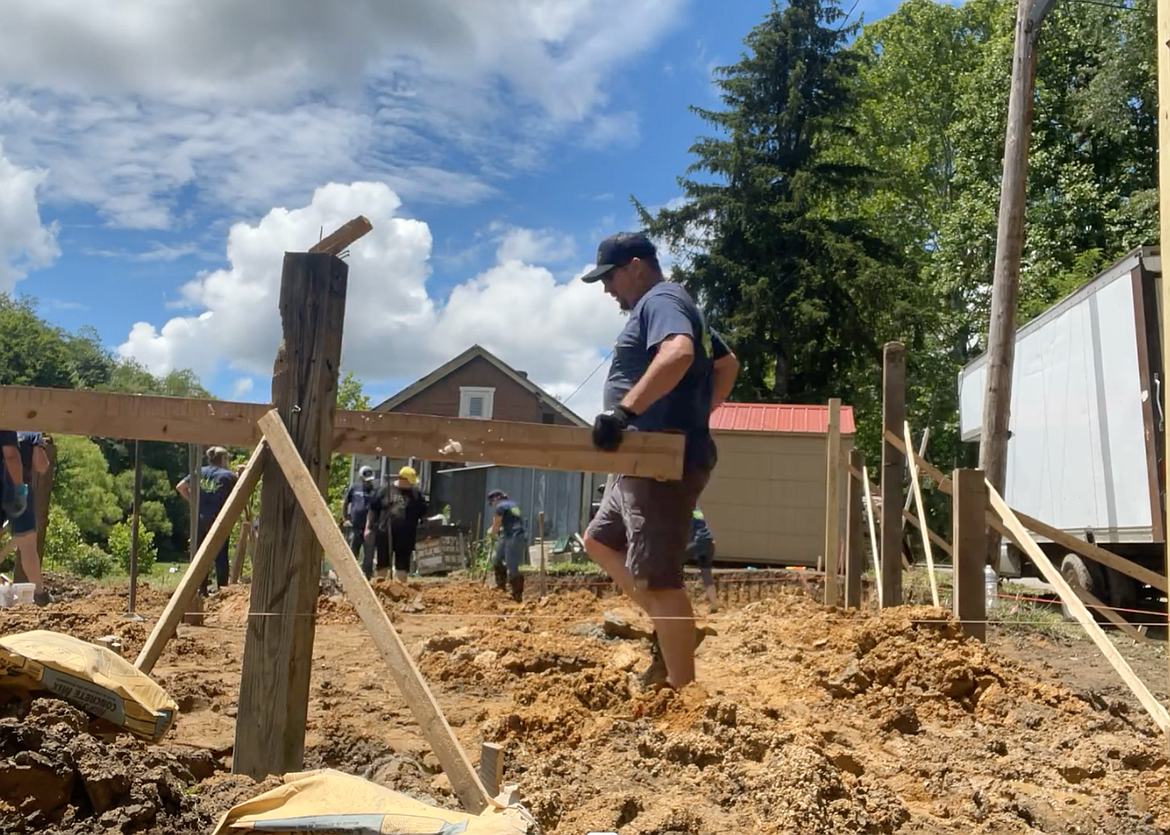 TJ Clary, Heather Draggo (right), and Heather Lies (left) worked in the dry clay in the West Viriginia Appalachian Mountains doing foundation work for a family of seven whose trailer burned to the ground.