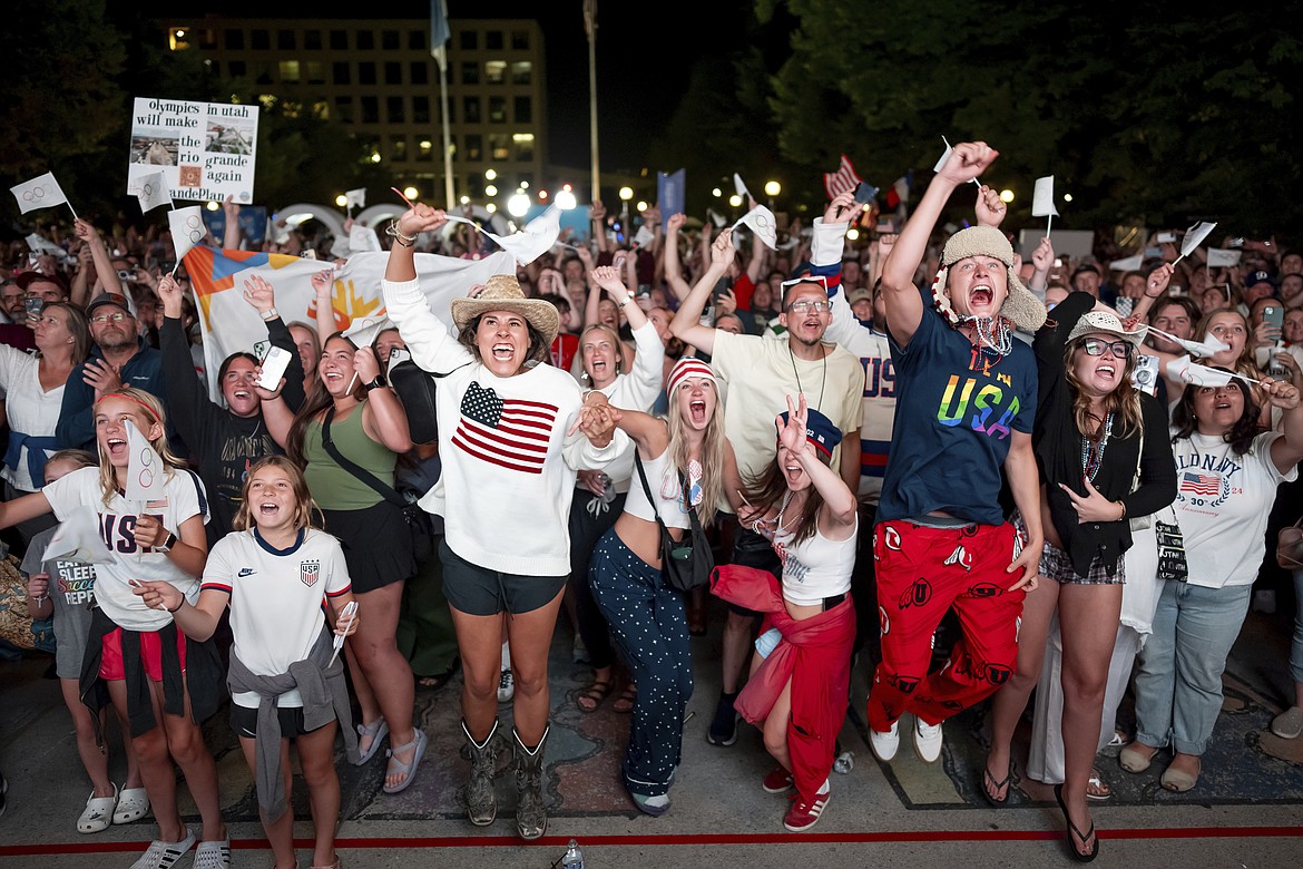 People celebrate while watching a live feed from Paris at the moment the International Olympic Committee awarded Salt Lake City the 2034 Winter Olympics, Wednesday, July 24, 2024, in Salt Lake City. (AP Photo/Spenser Heaps)