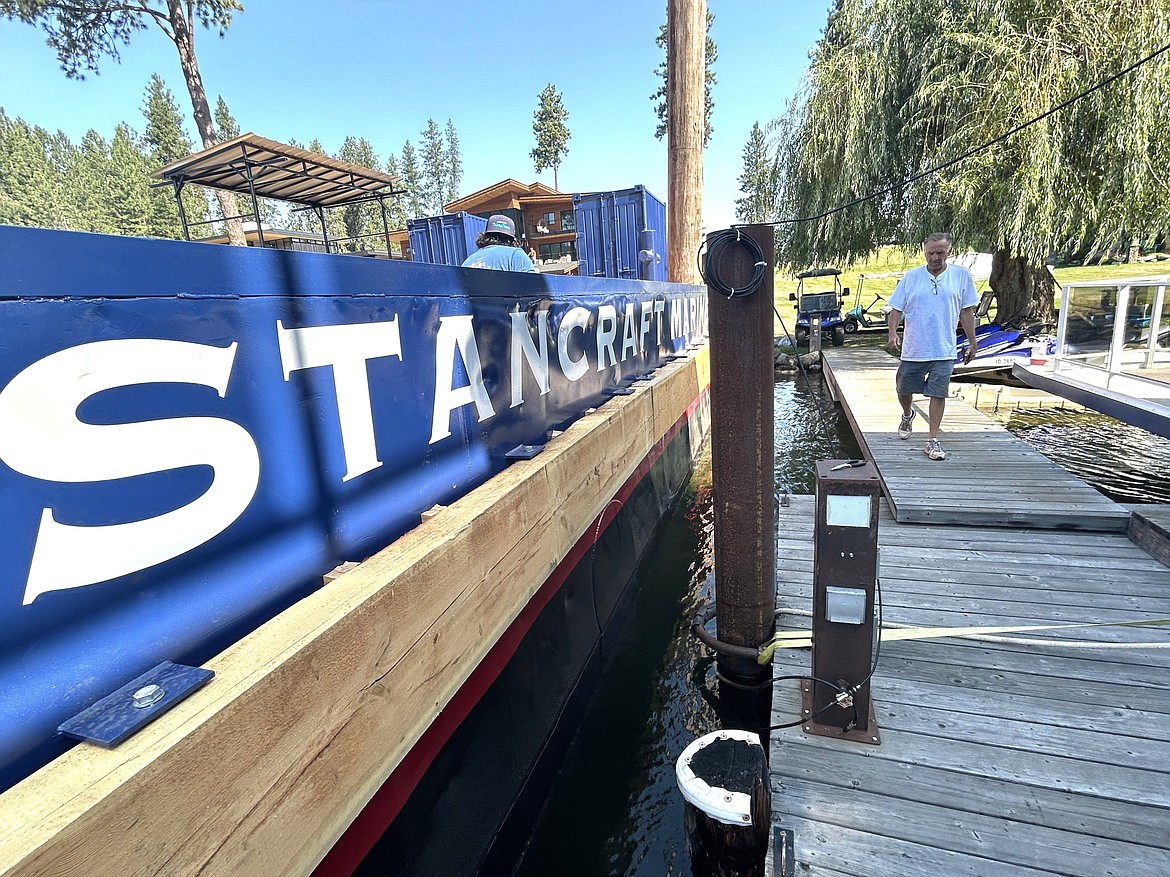 Fred Finney of Finney Boat Works walks on the dock to inspect the barge as it returns to North Idaho waters on Wednesday.