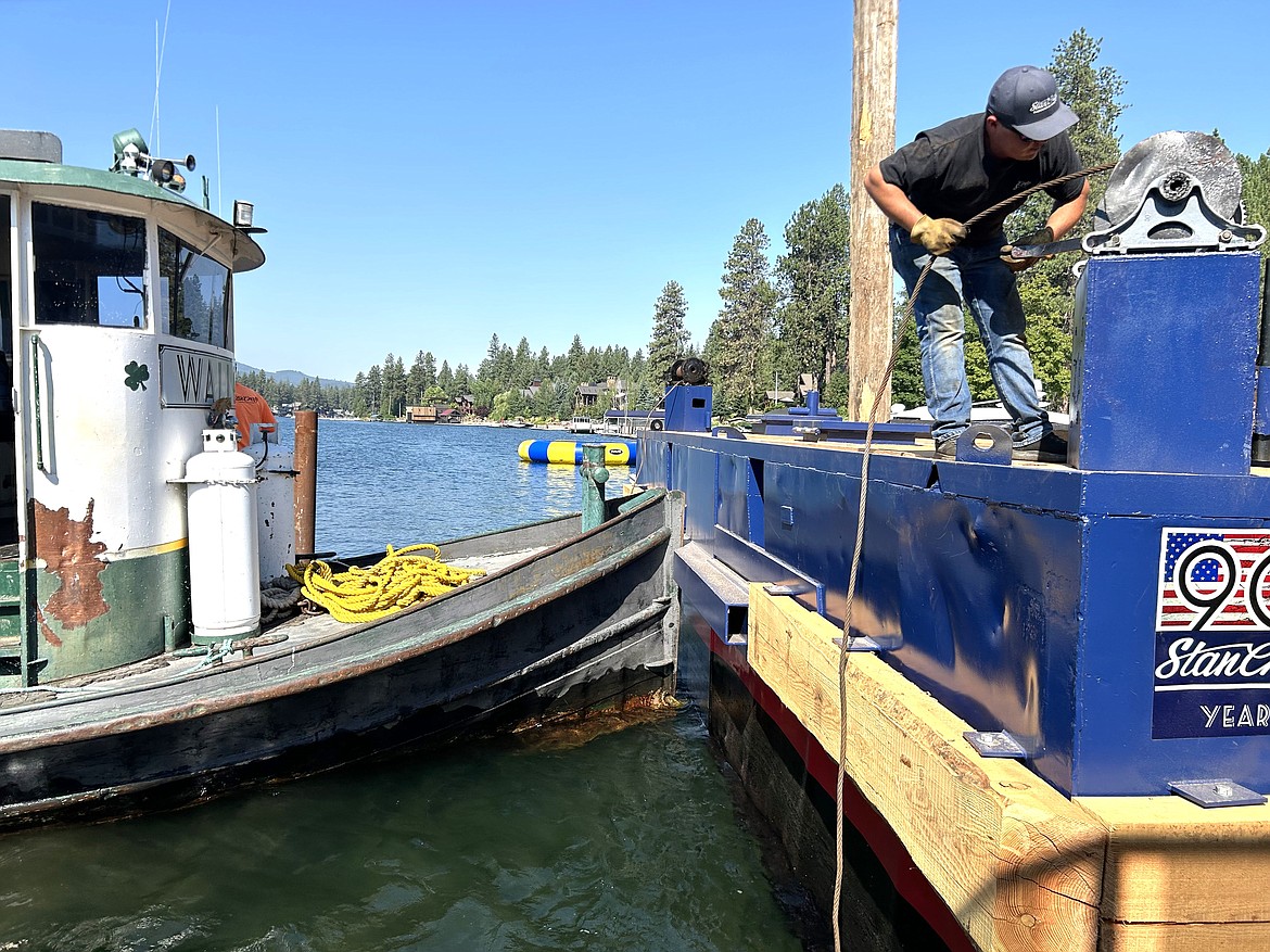 Walle, a StanCraft Marine Construction tug, noses up to a barge on Wednesday on the Spokane River at Finney Boat Works.