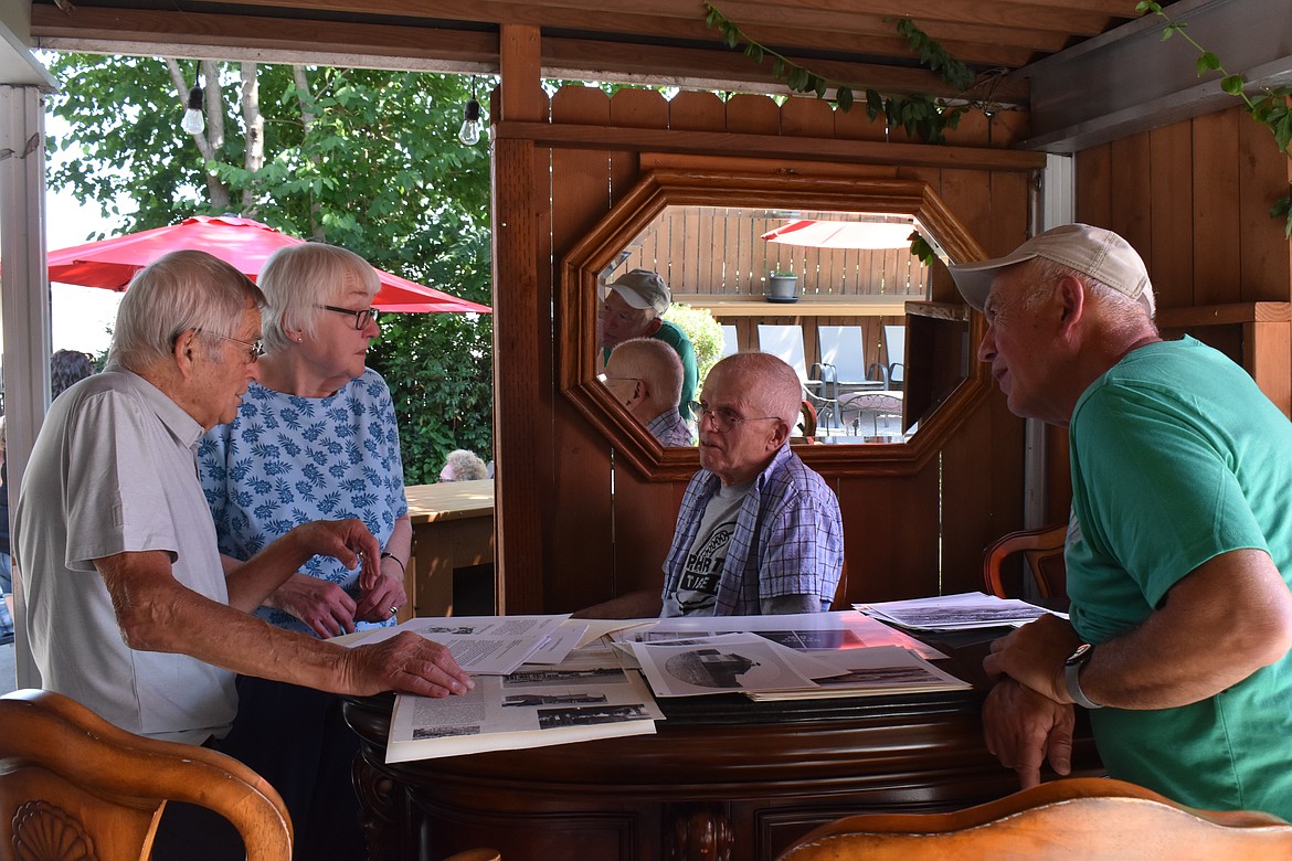 Visitors at the Nat Washington House talk about the history of the place during a gathering this last Saturday.