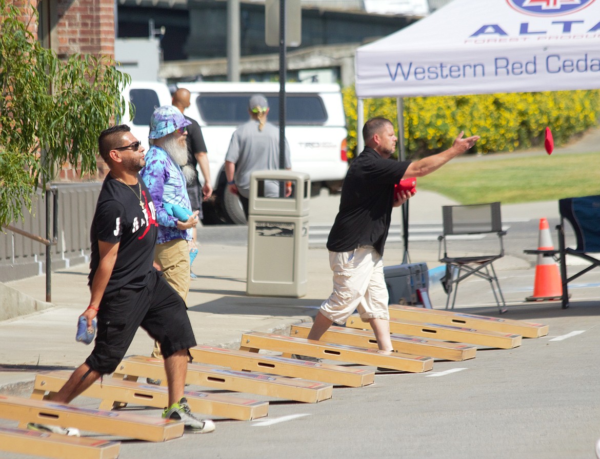 Participants in the Fry Healthcare Foundation cornhole tournament compete in downtown Bonners Ferry on Saturday, July 20.