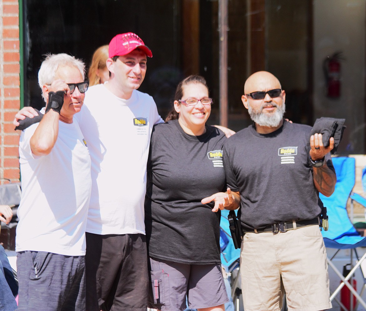 A cornhole team takes a photo before the FHF cornhole tournament starts.