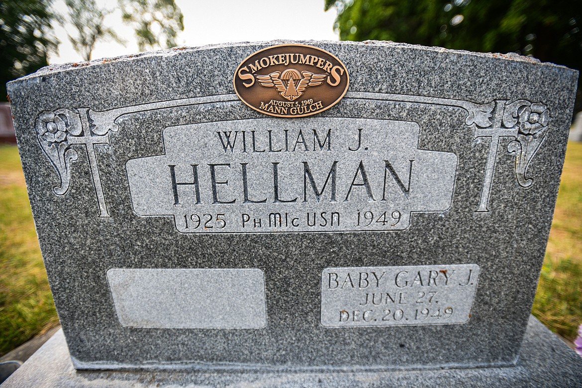 The gravestone of William James Hellman, one of 13 firefighters who died in the Mann Gulch Fire in August 1949, at C.E. Conrad Memorial Cemetery in Kalispell on Thursday, July 25. (Casey Kreider/Daily Inter Lake)