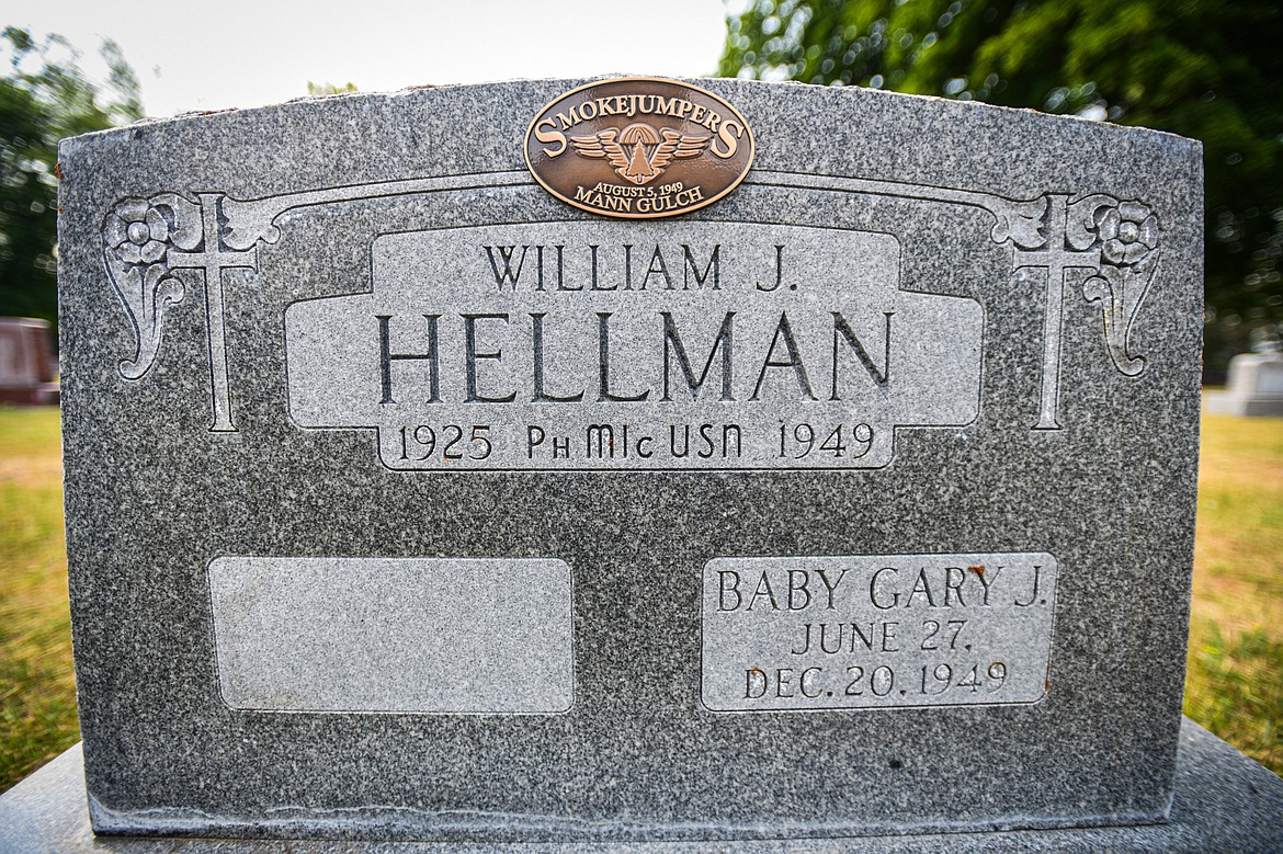 The gravestone of William James Hellman, one of 13 firefighters who died in the Mann Gulch Fire in August 1949, at C.E. Conrad Memorial Cemetery in Kalispell on Thursday, July 25. (Casey Kreider/Daily Inter Lake)