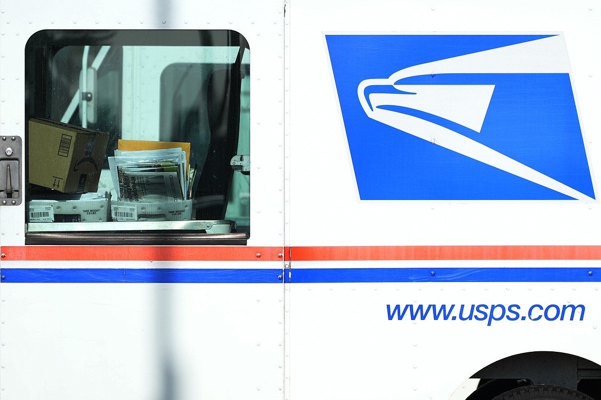 Letters and packages are loaded on a U.S. Postal Service truck parked outside a post office in Wheeling, Ill., Monday, Jan. 29, 2024. (AP Photo/Nam Y. Huh, File)