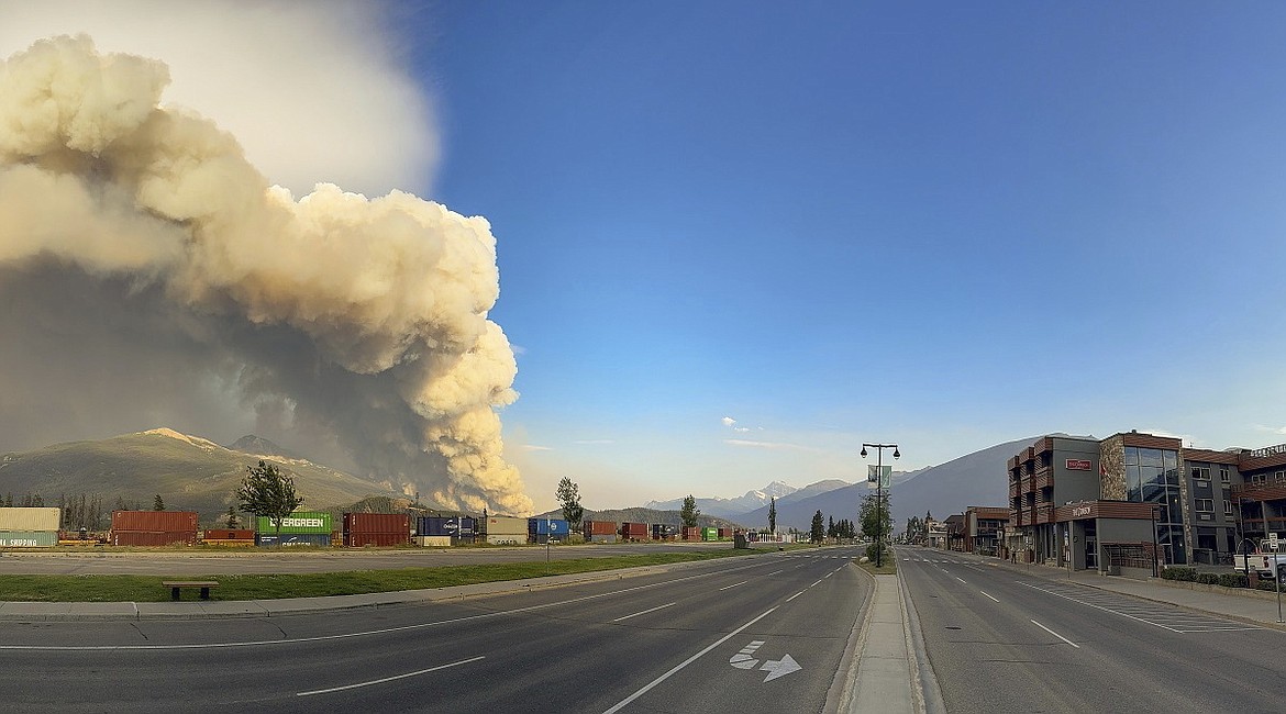 In this photo released by the Jasper National Park, smoke rises from a wildfire burning near Jasper, Alberta, Canada, Wednesday, July 24, 2024. (Jasper National Park via The Canadian Press via AP)