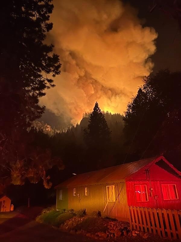 Smoke smolders over a home in Yakima County Tuesday night as the Retreat Fire continues to expand. The initial fire broke out at 3:45 p.m. on Tuesday and by Thursday had expanded to 8,000 acres. There are multiple evacuation orders in effect according to the Yakima Fire Department.