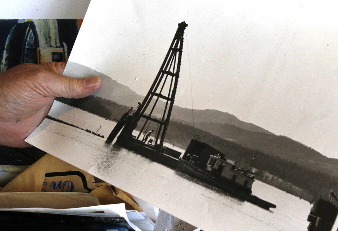 Skip Murphy holds a photo of the marine pile driver his dad took up and down Lake Coeur d'Alene while selling pilings to people along the way. “It had enough room in the back that you could put bunks in it," Skip said.