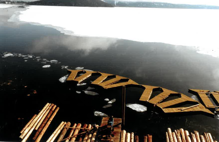 Docks and marina slip pieces are floated from the Murphy Marine Construction shop at Casco Bay to The Coeur d'Alene Resort in the winter of 1984-85.