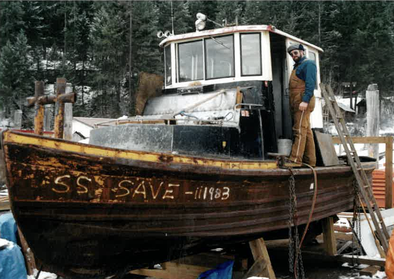 Skip Murphy stands on the SS SAVE tugboat the winter after the boardwalk was built.