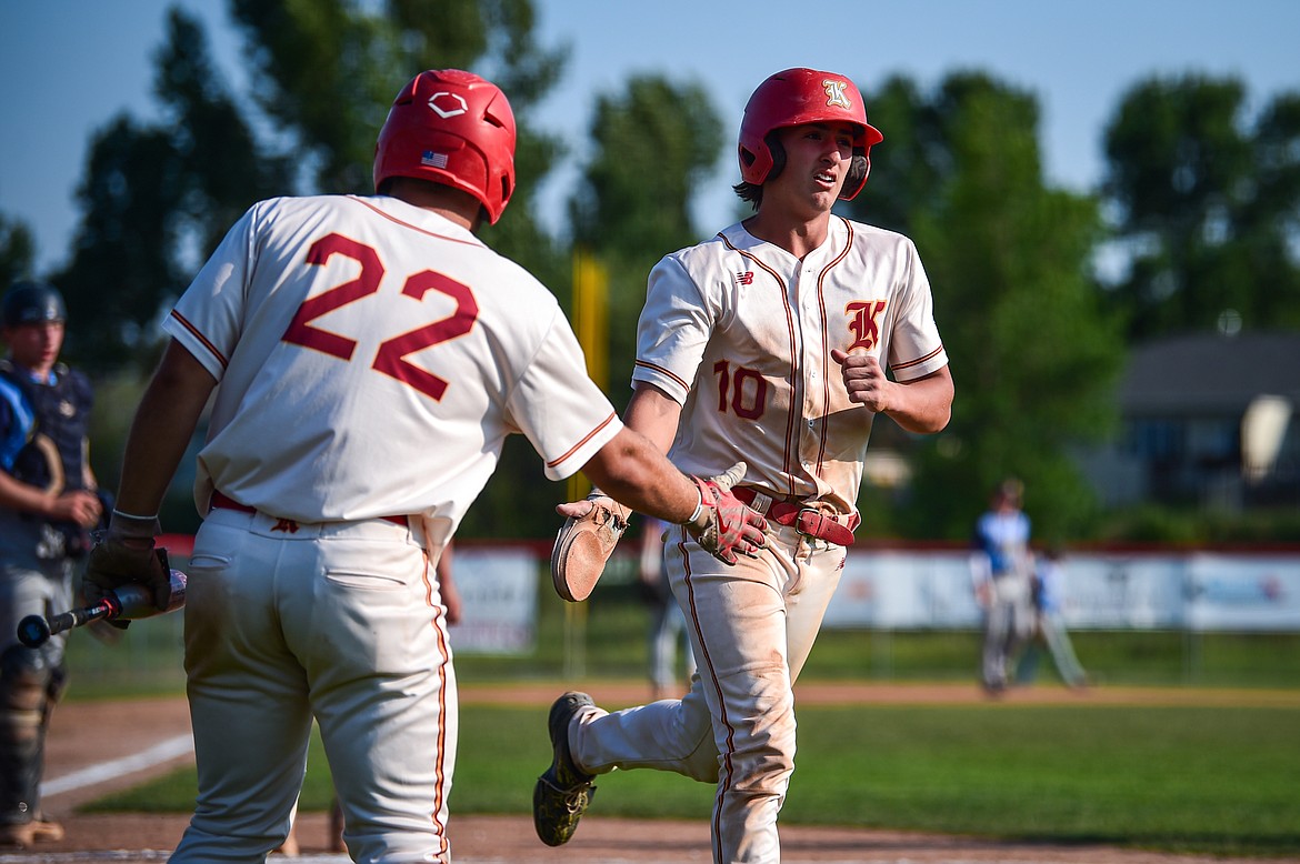 Kalispell's Trever Cockerill (22) congratulates Ostyn Brennan (10) after Brennan scored in the fourth inning against Great Falls at Griffin Field on Friday, July 26. (Casey Kreider/Daily Inter Lake)