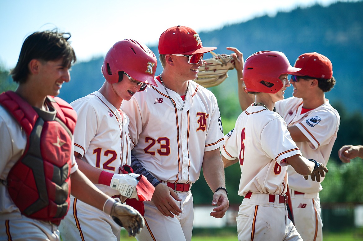 Kalispell's Ostyn Brennan (10), Luke Nikunen (12), Brysen Herion (23), Kaden Drish (6) and Bryce Buckmaster (17) celebrate after Trever Cockerill's two-run double plated Nikunen and Drish in the first inning against Great Falls at Griffin Field on Friday, July 26. (Casey Kreider/Daily Inter Lake)