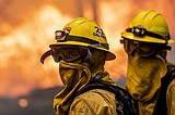 People flee town near Moscow, Idaho through a tunnel of fire and smoke as Western wildfires spread