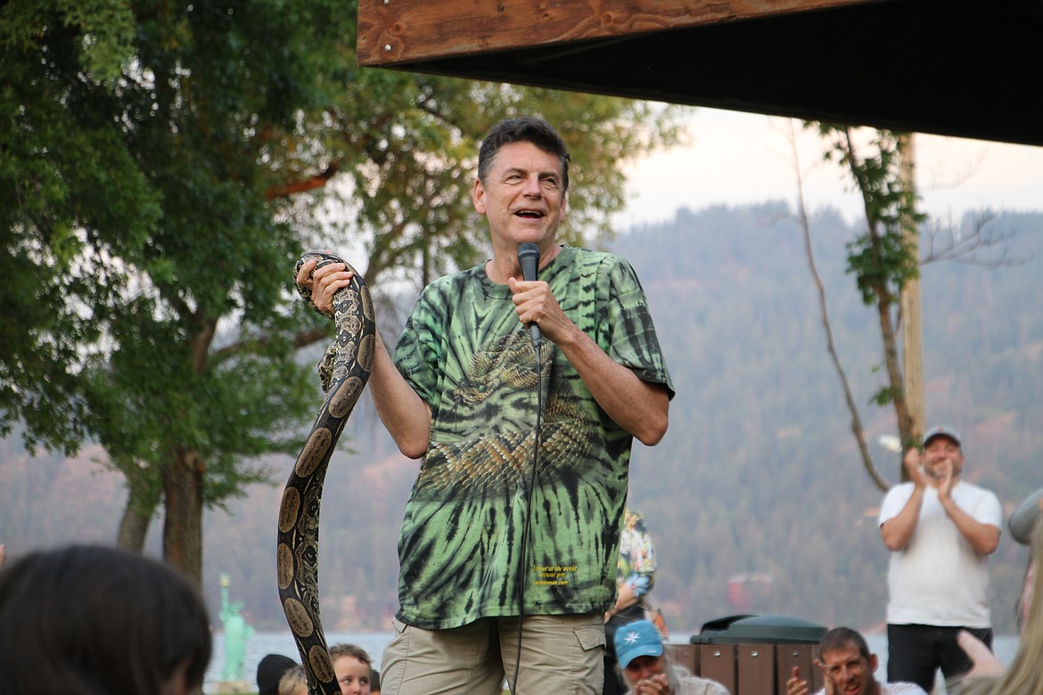 Peterson holds a boa constrictor before the audience.