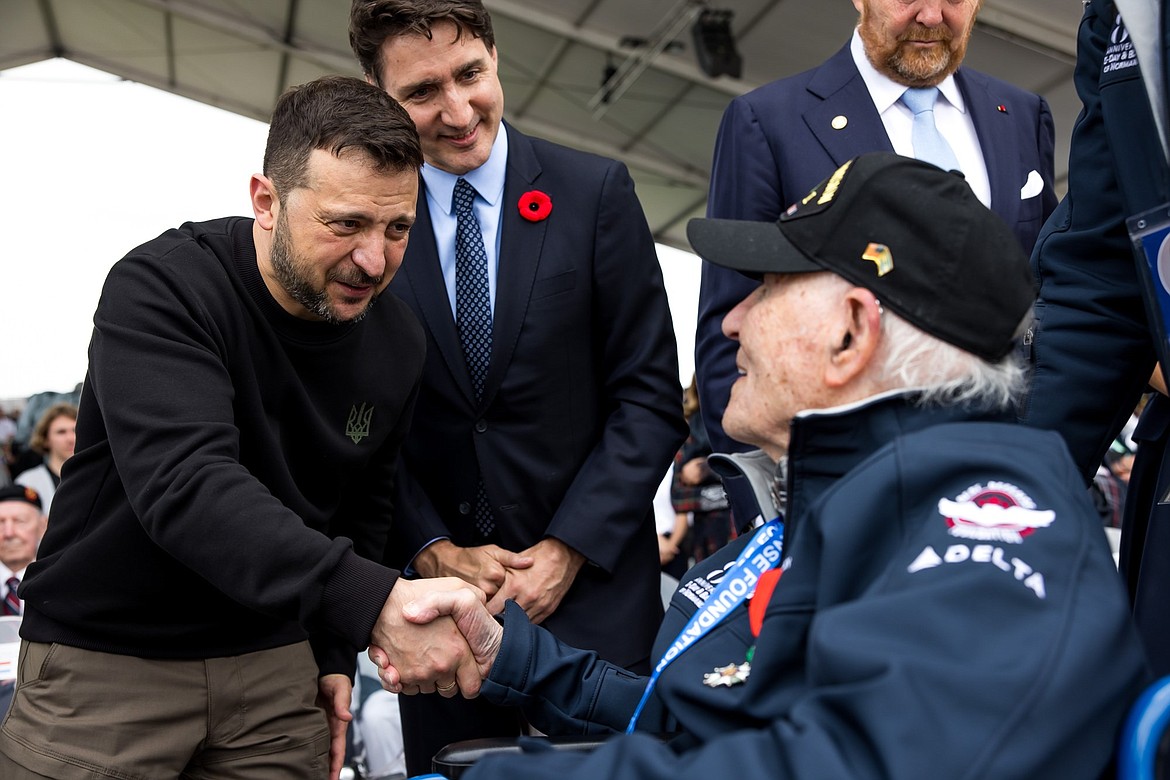 Ukrainian President Volodymyr Zelensky shakes the hand of Hilbert “Hibby” Margol, 100, during the International D-Day ceremony on Omaha Beach on Thursday, June 6, 2024.