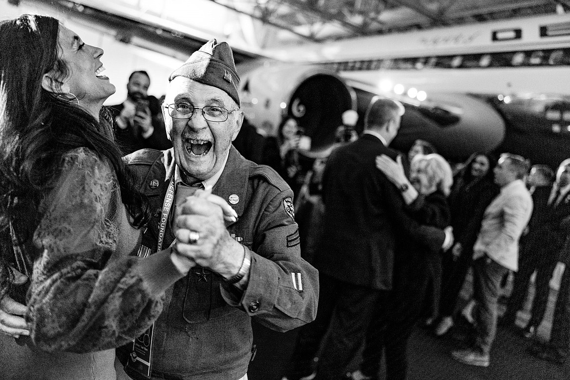 Wilbur “Jack” Myers, 100, is all smiles Saturday, June 1, 2024 during the sendoff celebration at the Delta Airlines museum in Atlanta, Georgia as he dances with Brianna Streeter, a member of the Best Defense Foundation medical staff.