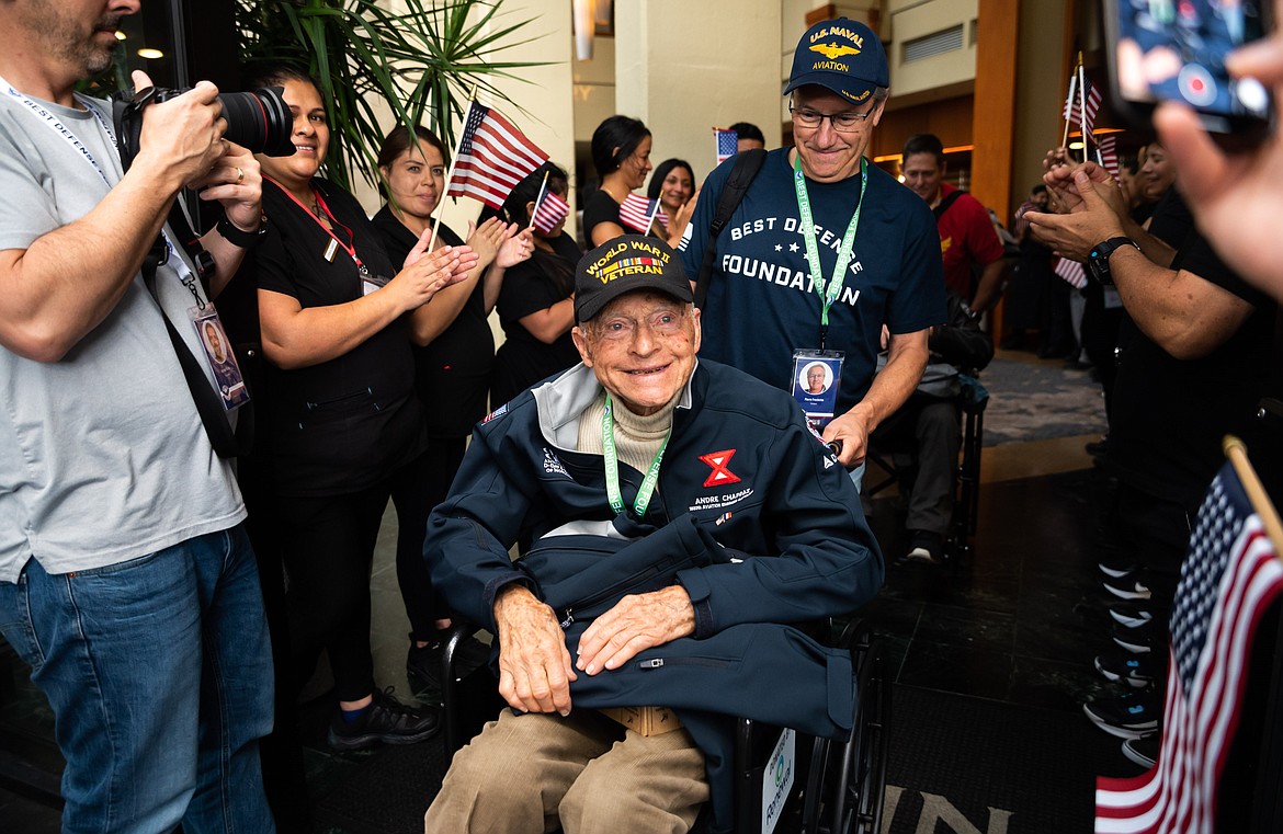 A veteran receives cheers during his visit to Normandy in June.