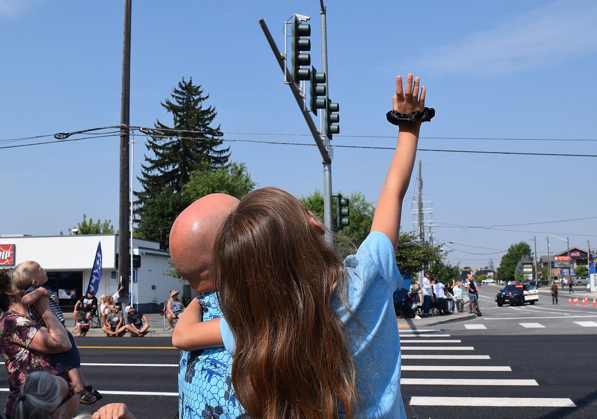 Reaching for the skies: Elisabeth, 9, and her dad, Timmy Sr., look up as No Limits Aviation conducts their annual flyover.