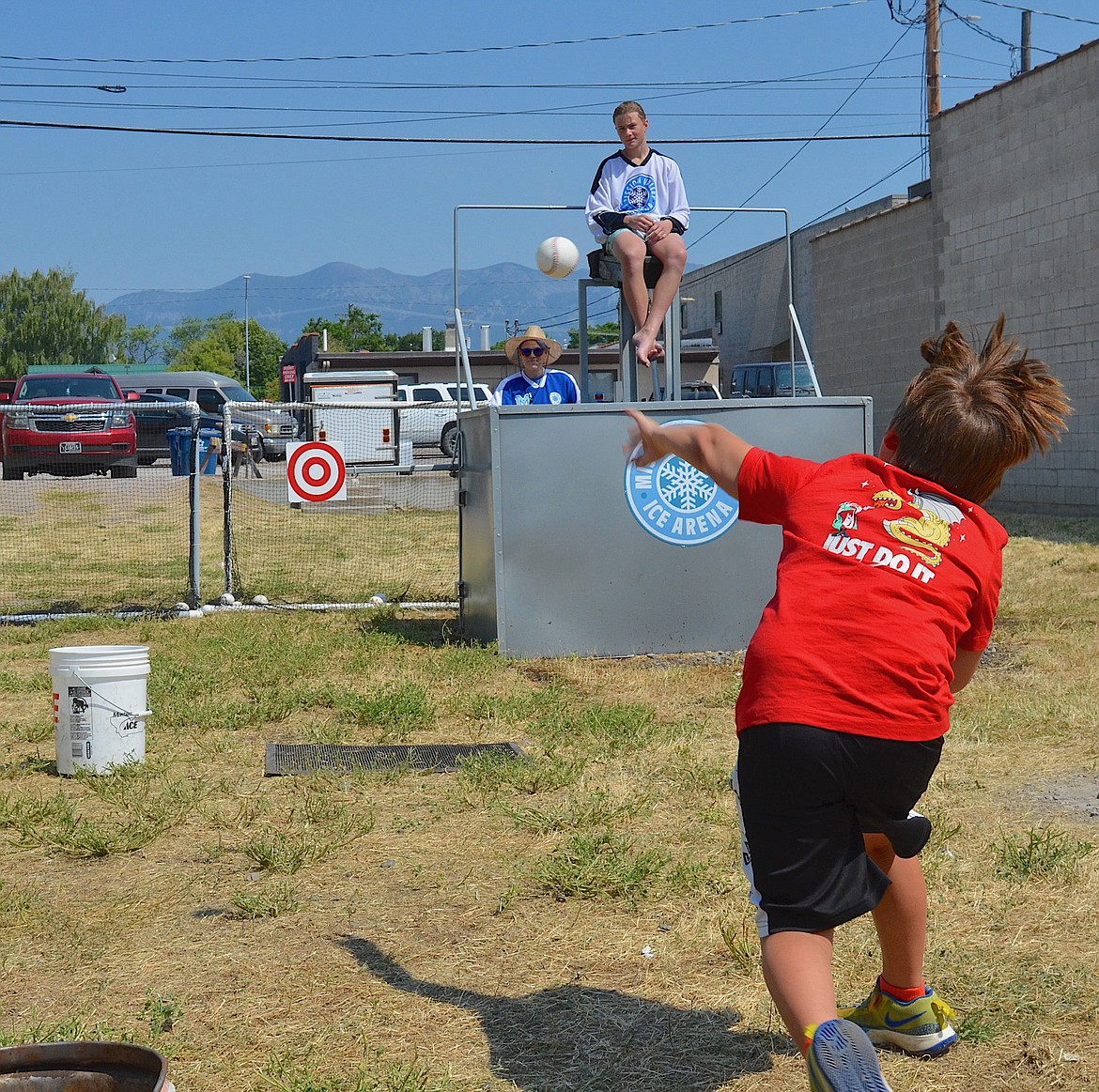 Jase Caye practiced his pitching skills Saturday at the Mission Valley Ice Arena dunking booth. While Jase didn't quite hit the target, plenty of others did during the Flathead Cherry Festival. (Kristi Niemeyer/Leader)