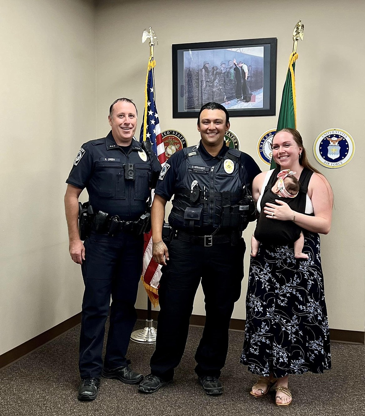 Diego Hernandez, the newest officer at Quincy Police Department,  poses for a photo with Quincy Police Chief Ryan Green and his wife and daughter. Hernandez said he is excited to serve his community.