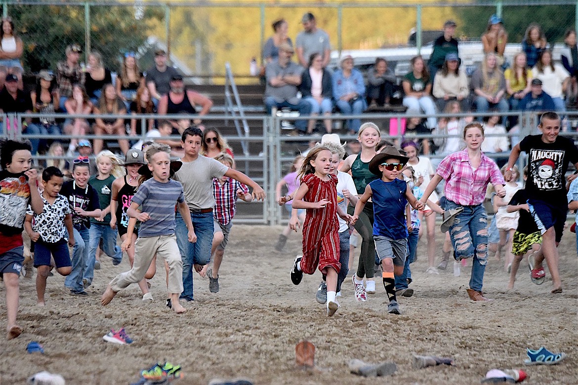 Kids of all ages made a mad dash in the boot scramble Friday, July 26, 2024, at the Kootenai River Stampede in Libby. (Scott Shindledecker/The Western News)