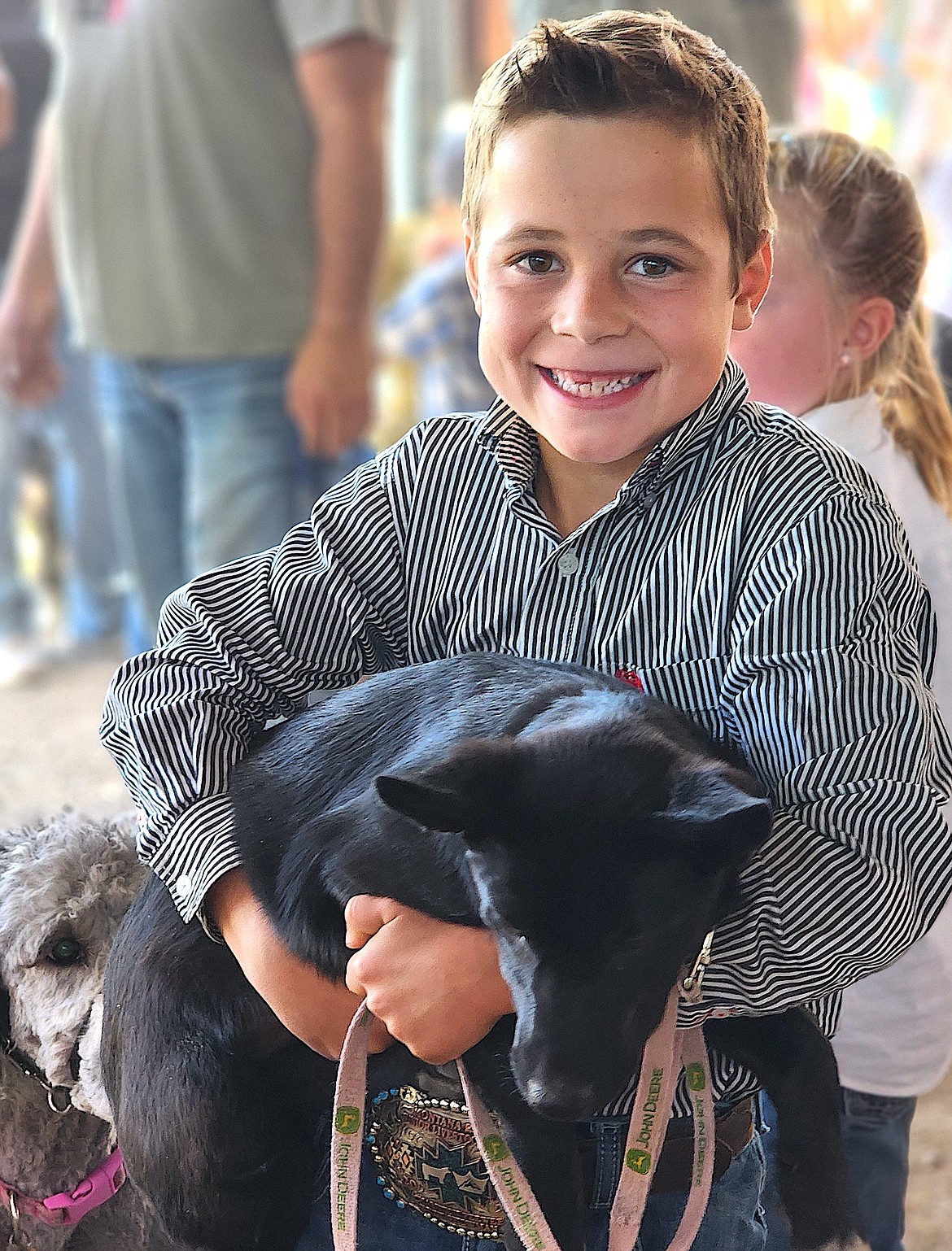 Kesten Cahoon comes out of the ring smiling after showing the Cahoon family's Kelpie cross puppy in the Small Fry Stock Show. (Berl Tiskus/Leader)