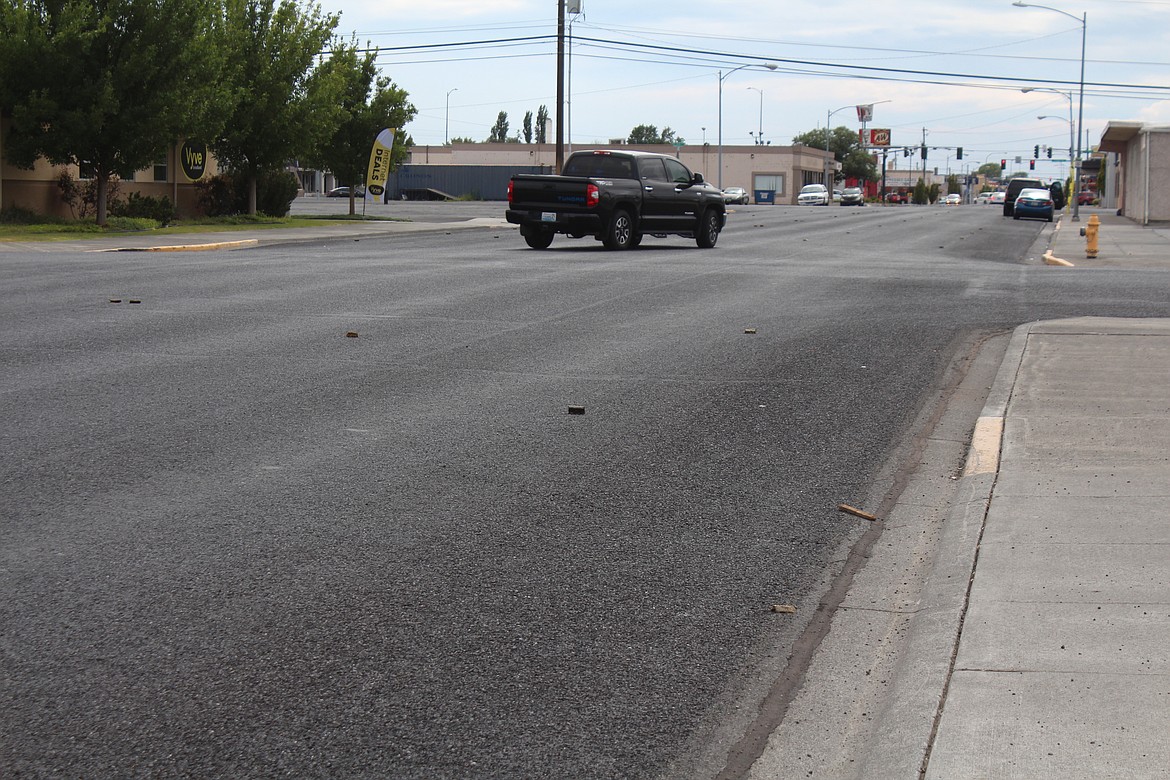 A section of East Broadway Avenue awaits striping after being seal coated.