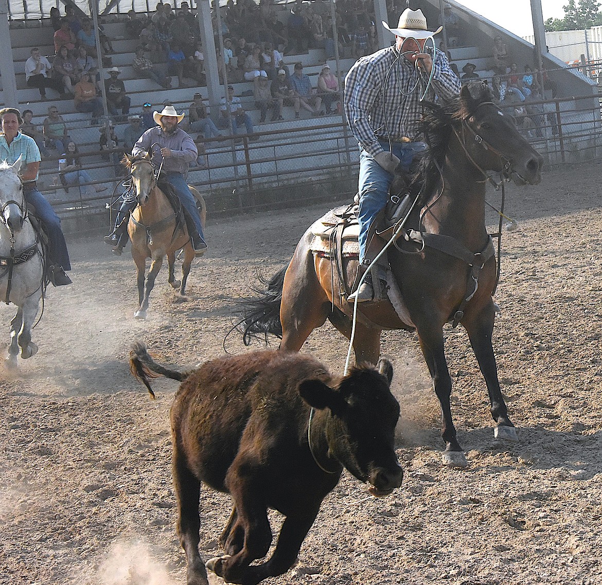 During Saturday's Ranch Rodeo at the Ronan Fairgrounds, a contestant ropes his team's steer, which the muggers have to tie down. Then the entire team needs to be a horseback before they receive a time. (Berl Tiskus/Leader)