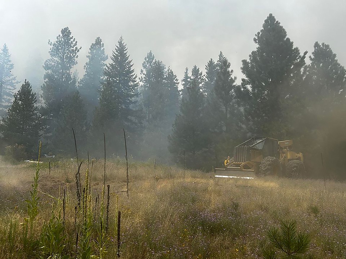 Firefighters work to contain the Schneiders Road fire Monday afternoon.