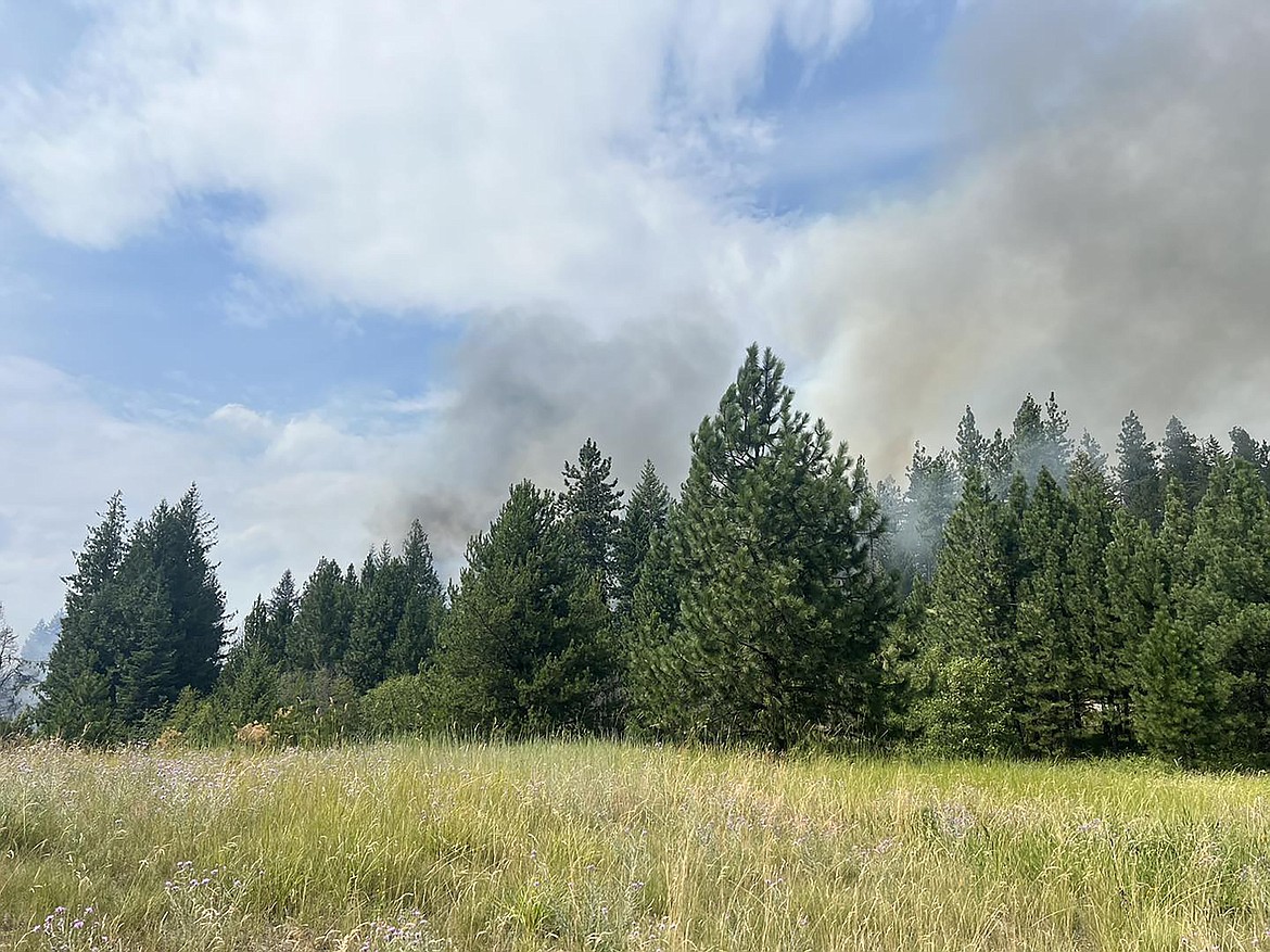 Smoke can be seen from the Schneiders Road area after a structure fire was reported early Monday afternoon. The fire destroyed two homes and two outbuildings and, as of Monday evening, just under 4 acres of heavy brush and timber.