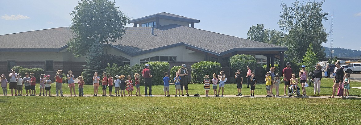 Families line up to launch their rockets at NASA Education and Outreach Specialist Jarrod Bales' presentation at Whitefish Community Library. (Photo provided by Library)