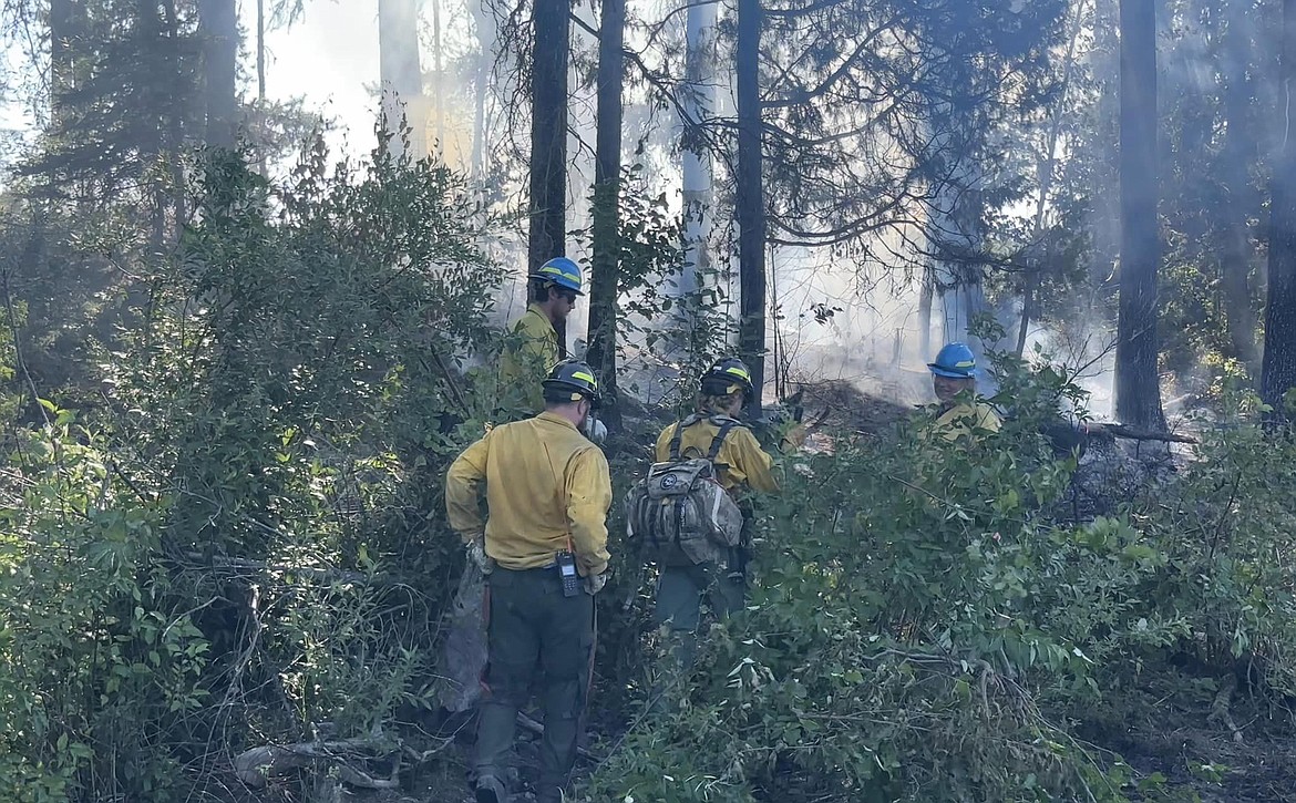 Firefighters put out a fire on an island in Stillwater Lake. (Olney Fire Department photo)