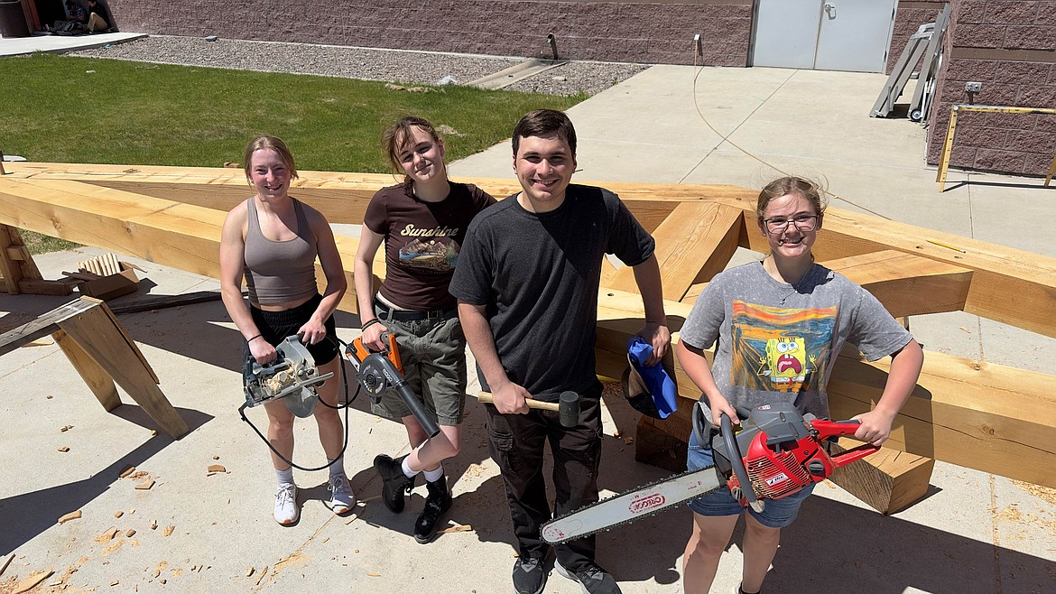 Glacier High School Outdoor Art students take a break from building a truss that was recently installed over one of the main parking lot entrances at the school. Students worked on the project during the 2023-24 year. Pictured left to right: Olivia Janetski-Biggs, Mandie Manning, Isaac Olson and Marin Colley. (Photo provided by C.J. Cummings)