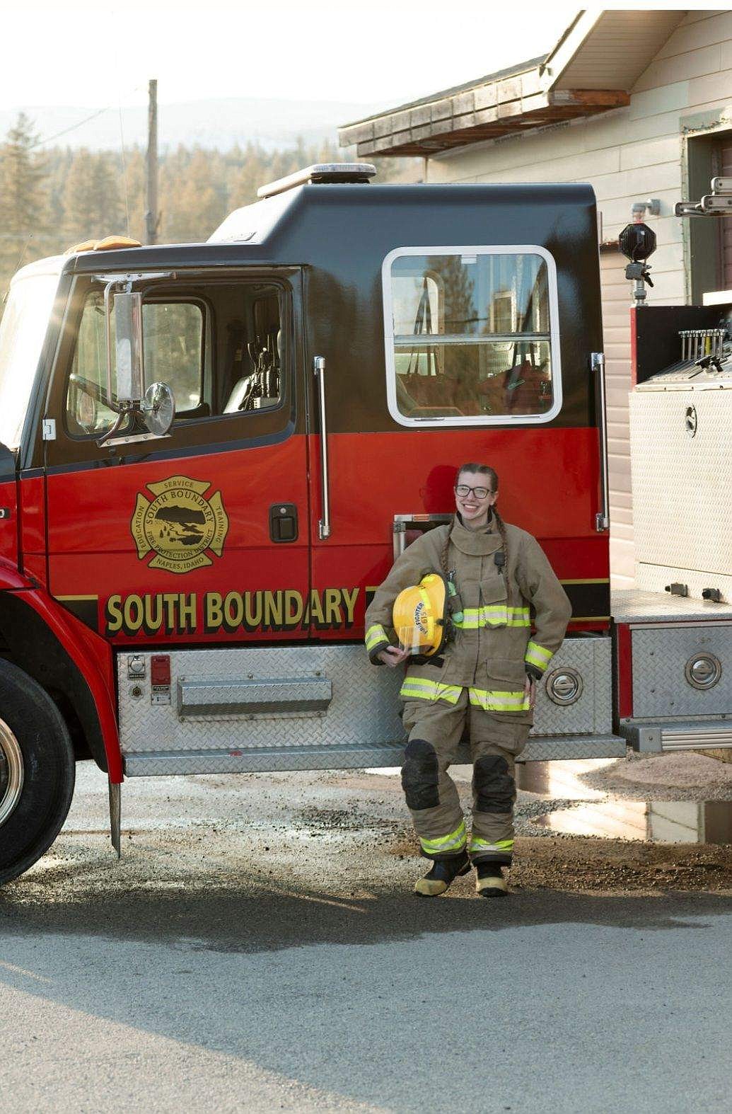 Alexis Vandecoevering in gear beside fire truck