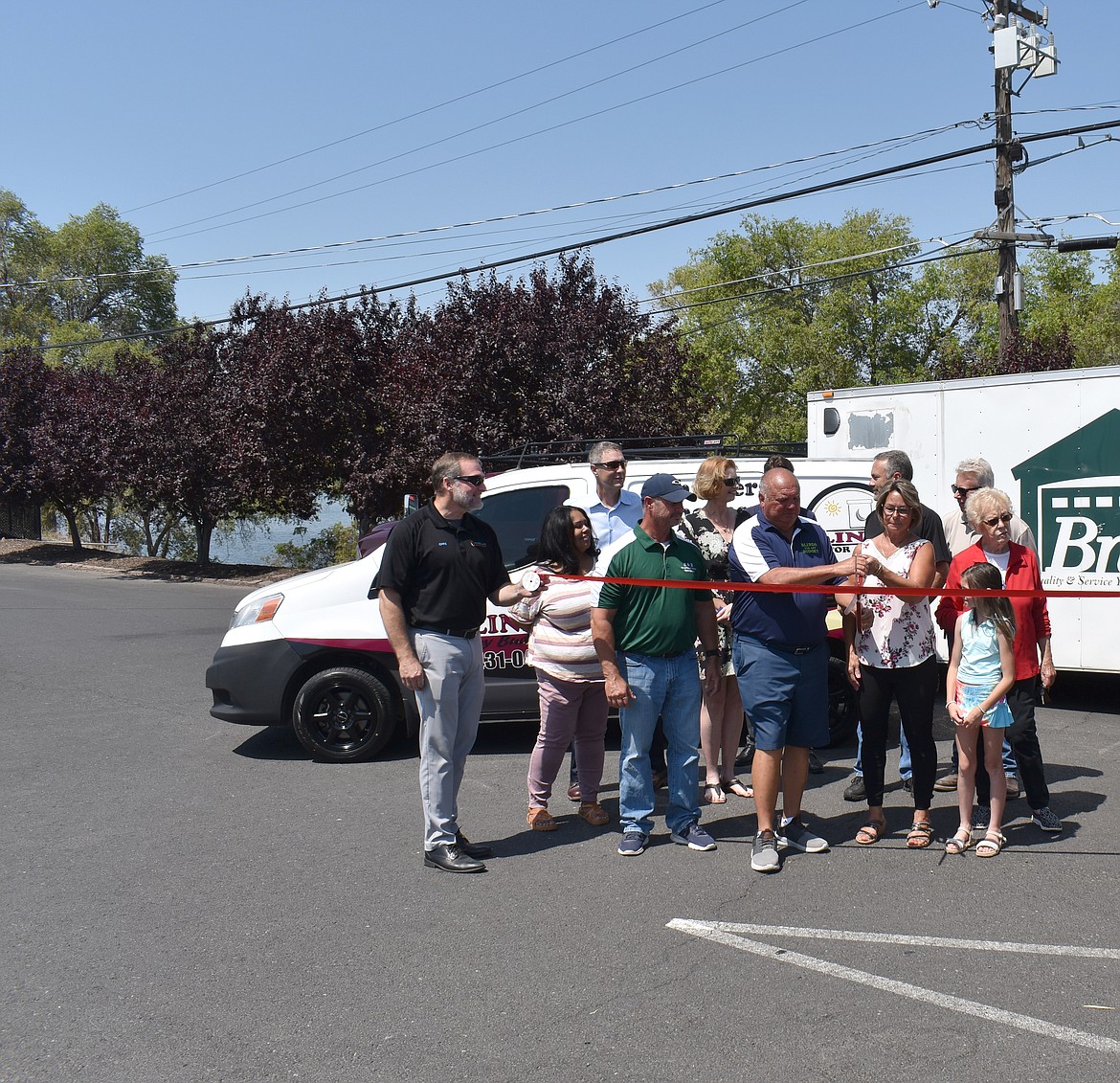 Kip and Ilene Burns cut the ribbon on the vans that hold their twin businesses Blinds for Any Budget and B and B Overhead Door Specialists in June 2023. Just over a year later, they’ve expanded across the Northwest.