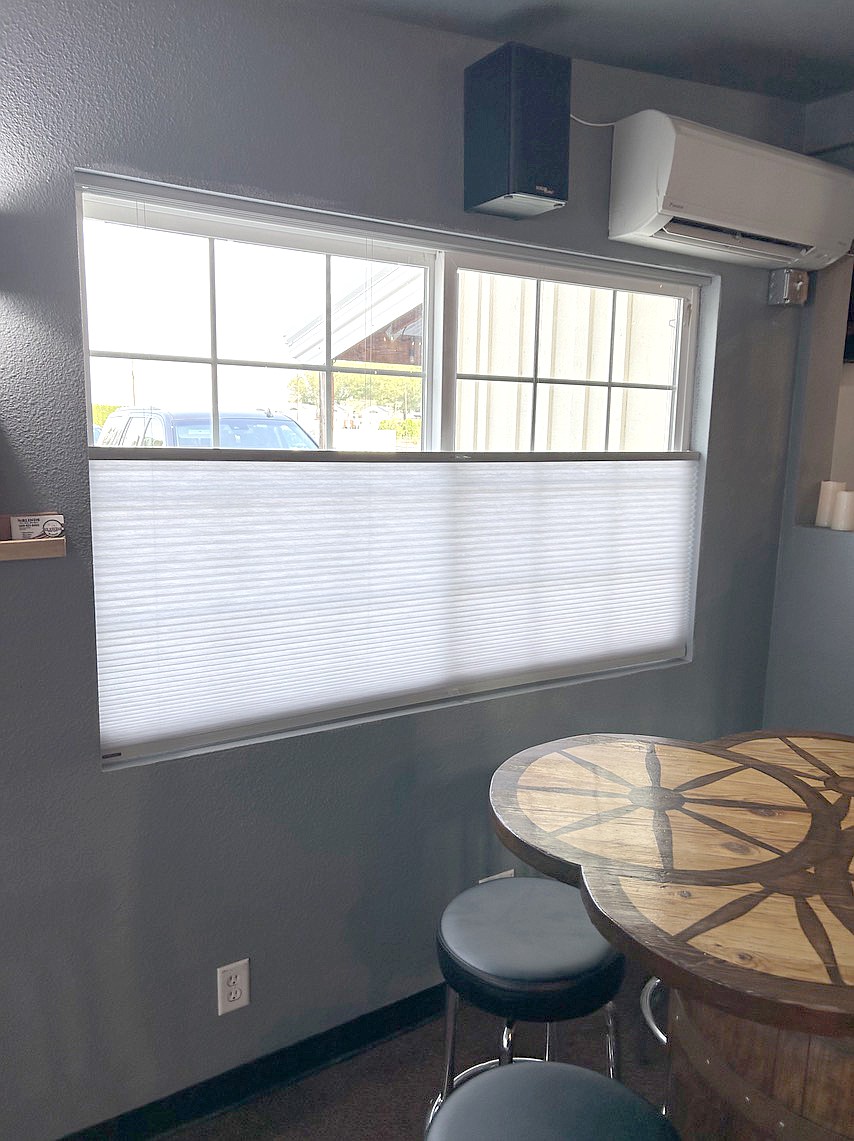 These blinds, installed by Blinds for Any Budget at a local restaurant, can roll down from the top or up from the bottom for maximum light and temperature control.