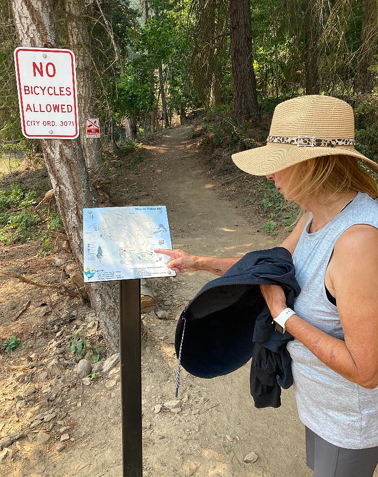 Recently, Eileen Oliveria Harrison of Costa Mesa, Calif., read directions at the new Tubbs Hill trailhead, west of the future Museum of North Idaho.